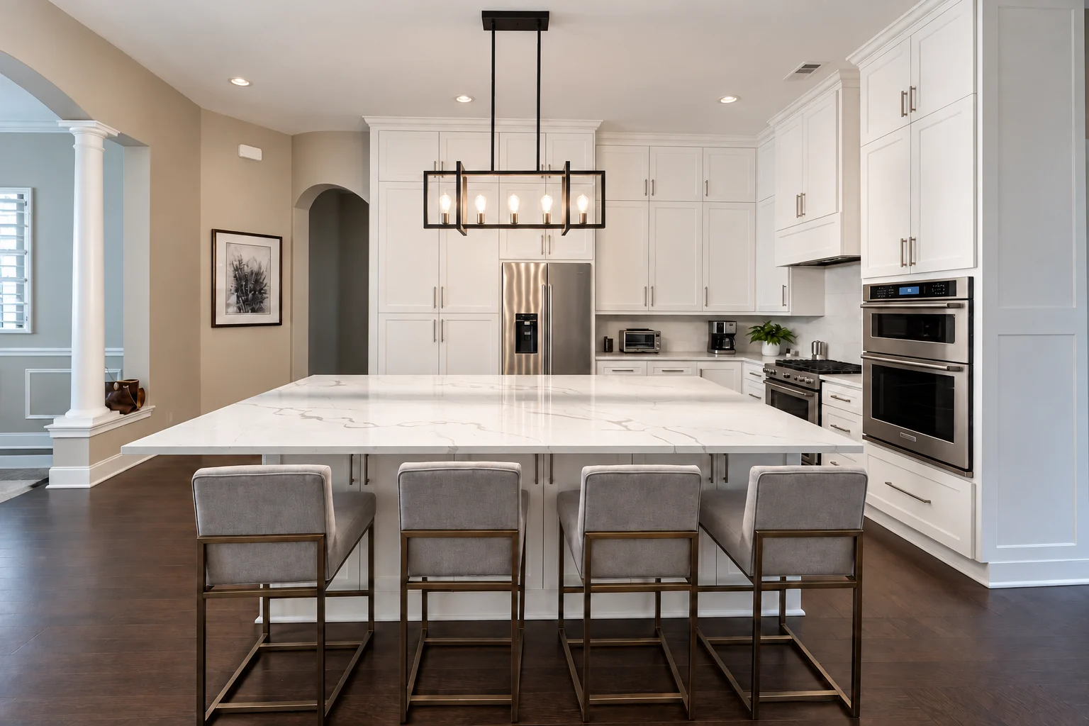 Wide white kitchen with a large island, cabinet wall, and seating