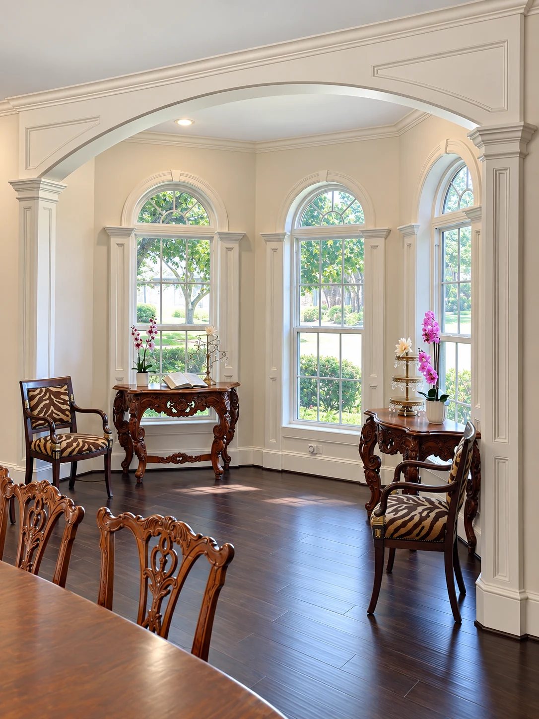 Dining room with an arched opening and tall windows