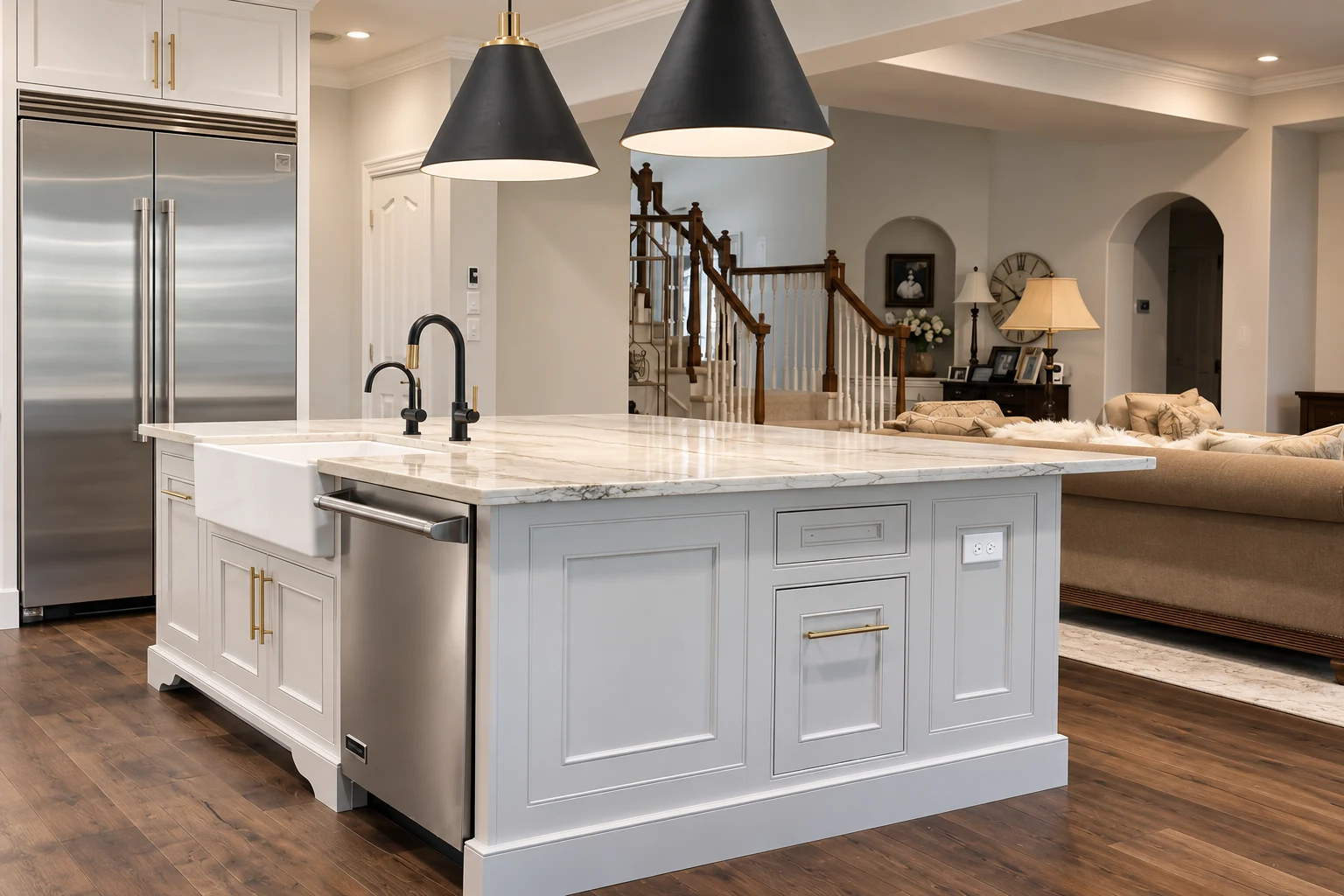 Light kitchen island with paneled cabinetry beneath pendant lights
